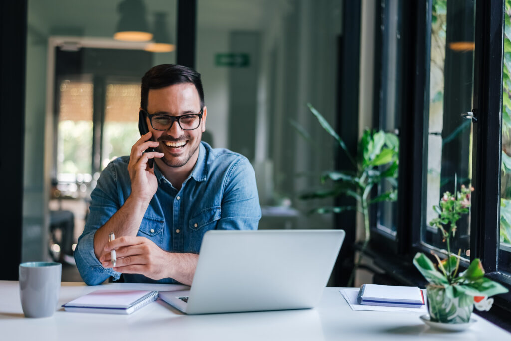 Portrait of young smiling cheerful entrepreneur in casual office